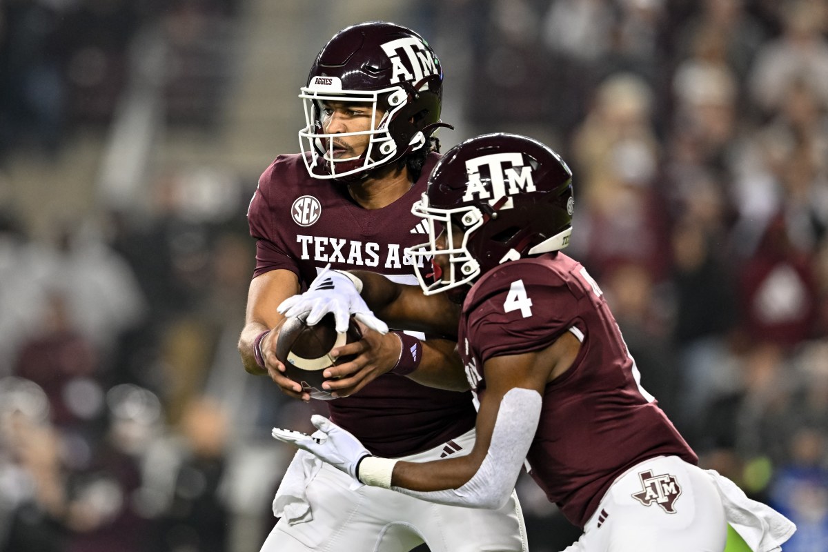 Nov 11, 2023; College Station, Texas, USA; Texas A&M Aggies quarterback Jaylen Henderson (16) hands off the ball to running back Amari Daniels (4) during the first quarter at Kyle Field.