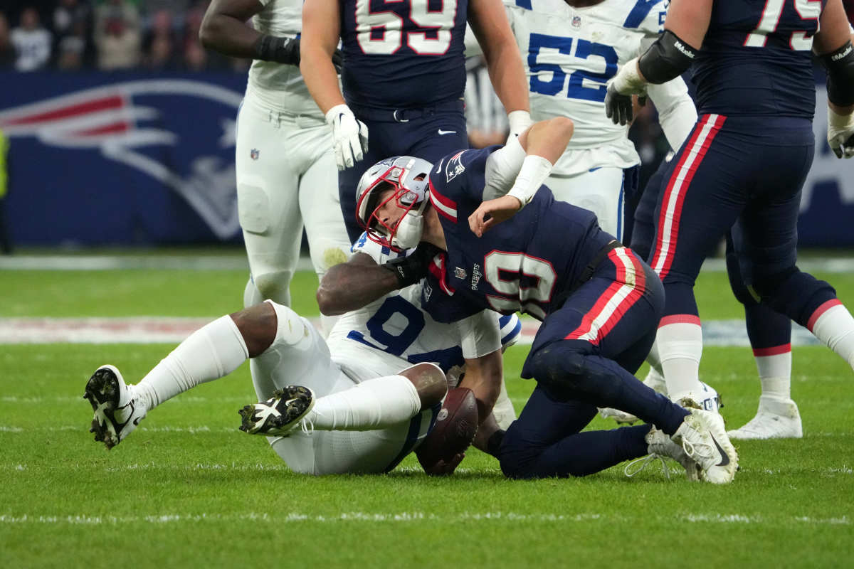 Indianapolis Colts defensive end Tyquan Lewis sacks New England Patriots quarterback Mac Jones in the first half during an NFL International Series game at Deutsche Bank Park.
