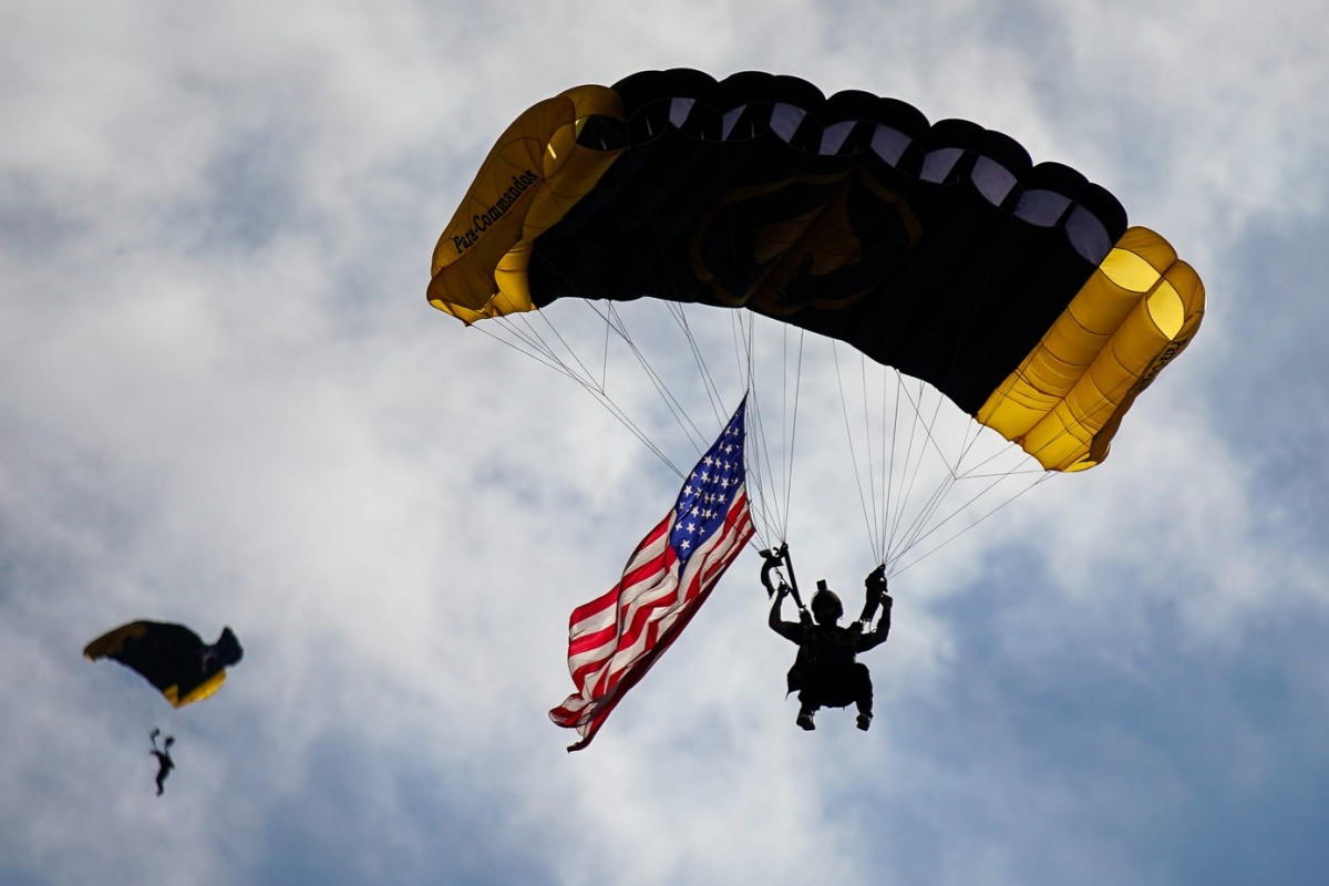Members of The Para-Commandos, the US Special Operations Command's aerial parachute demonstration team, land in the stadium before an NFL football game between the Tampa Bay Buccaneers and the Tennessee Titans at Raymond James Stadium.