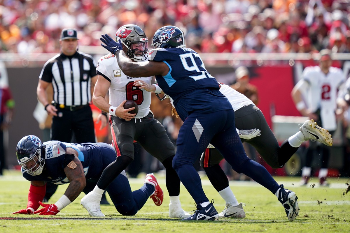 Tampa Bay Buccaneers quarterback Baker Mayfield (6) is brought down by Tennessee Titans defensive end Denico Autry (96) on a keeper.