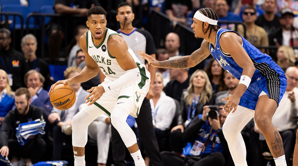 Bucks forward Giannis Antetokounmpo (34) posts up against Magic forward Paolo Banchero (5) during the first half at Amway Center.