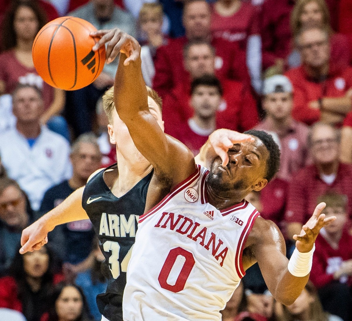 Indiana's Xavier Johnson (0) steals the ball from Army's Charlie Peterson (34) during the first half of the Indiana versus Army men's basketball game.