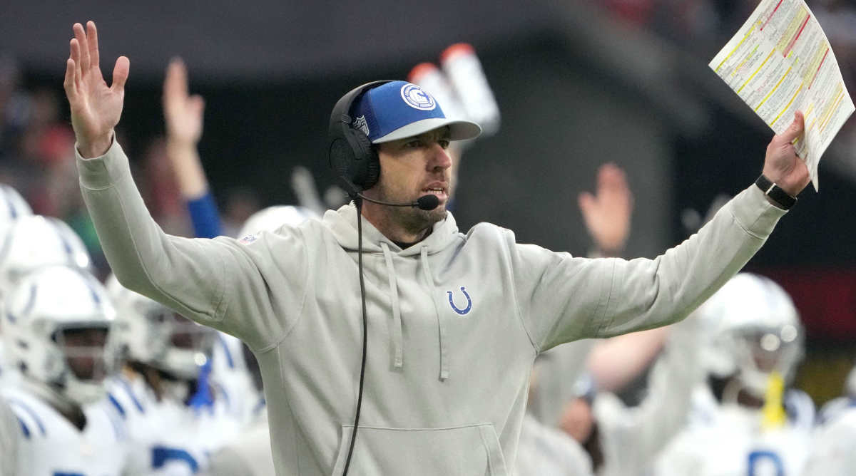 Colts coach Shane Steichen holds out his arms in a touchdown signal on the sideline