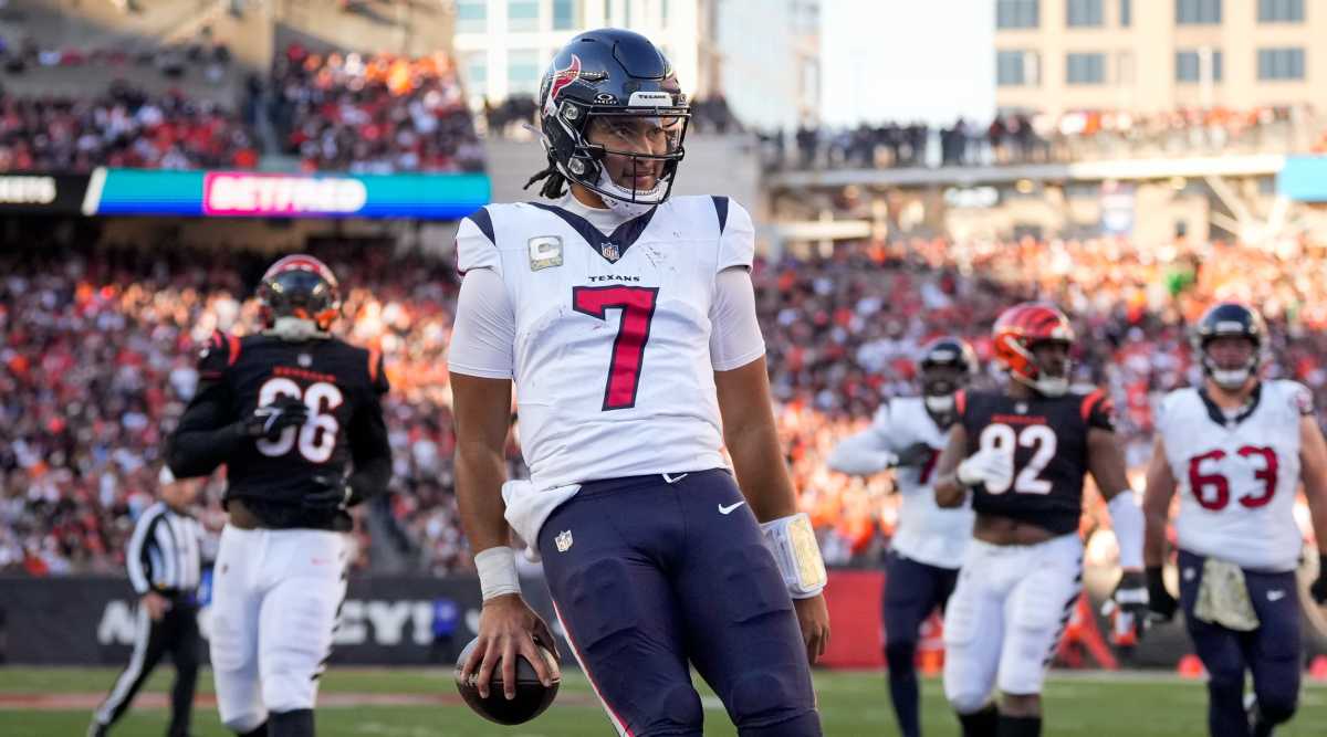 Texans quarterback C.J. Stroud looks defiant after running into the end zone with Bengals defenders trailing him