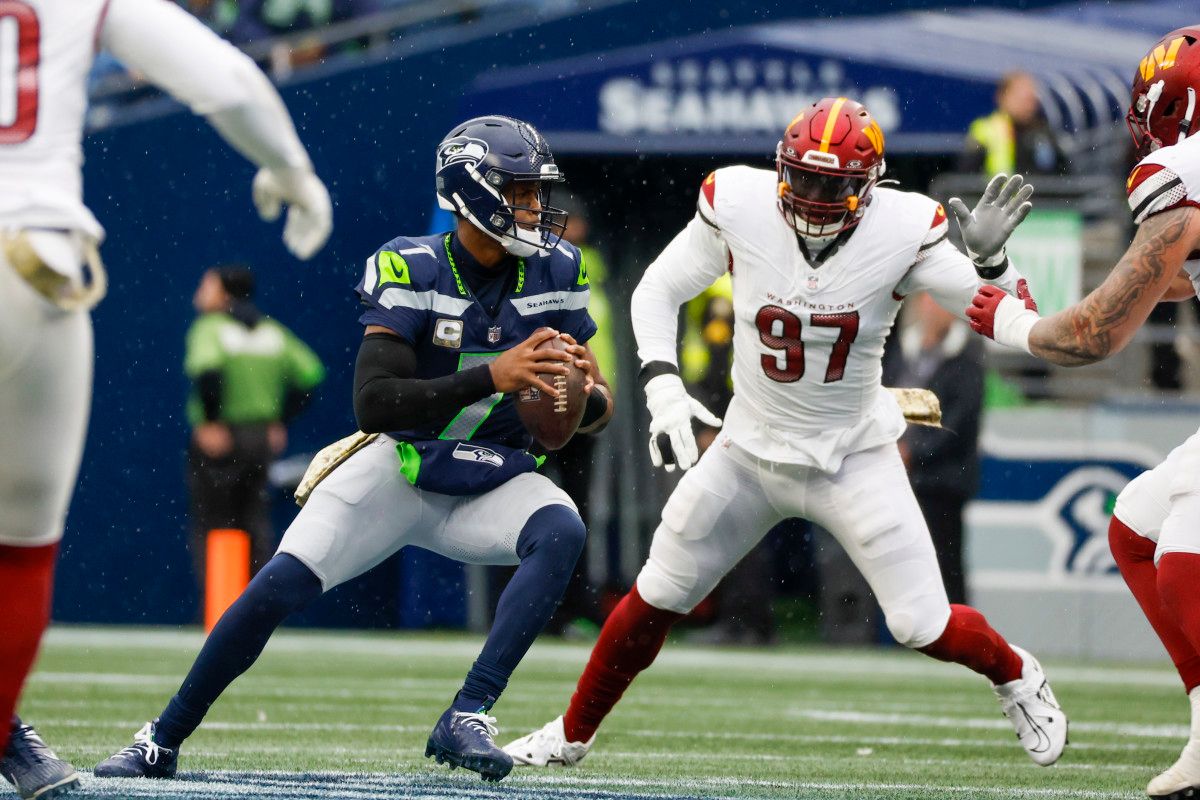 Seattle Seahawks quarterback Geno Smith (7) looks to pass against Washington Commanders defensive end Efe Obada (97) during the first quarter at Lumen Field.
