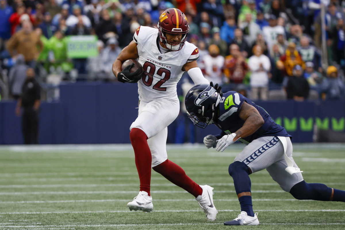 Washington Commanders tight end Logan Thomas (82) runs for yards after the catch against Seattle Seahawks safety Quandre Diggs (6) during the second quarter at Lumen Field.