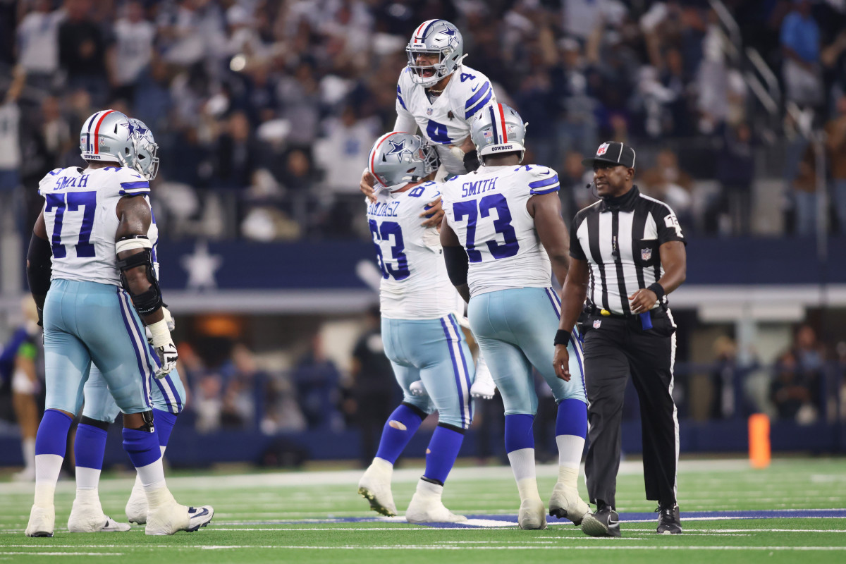 Dallas Cowboys quarterback Dak Prescott celebrates a touchdown against the New York Giants with center Tyler Biadasz (63) and offensive tackle Tyler Smith (73) in the third quarter at AT&T Stadium.