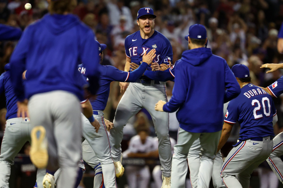 Texas Rangers relief pitcher Josh Sborz, center, reacts with teammates after defeating the Arizona Diamondbacks in Game 5 of the 2023 World Series at Chase Field in Phoenix.
