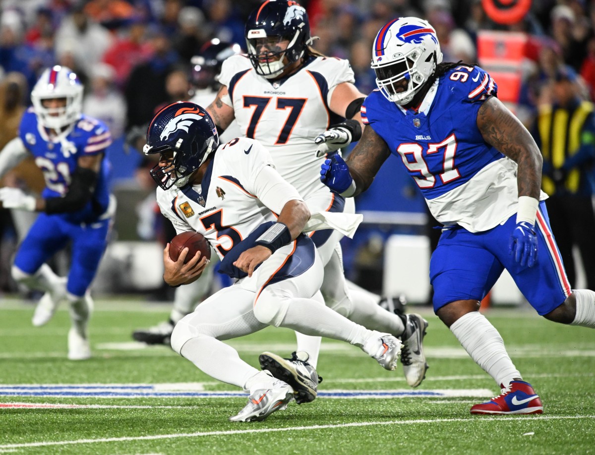 Broncos quarterback Russell Wilson runs against the Bills defense.