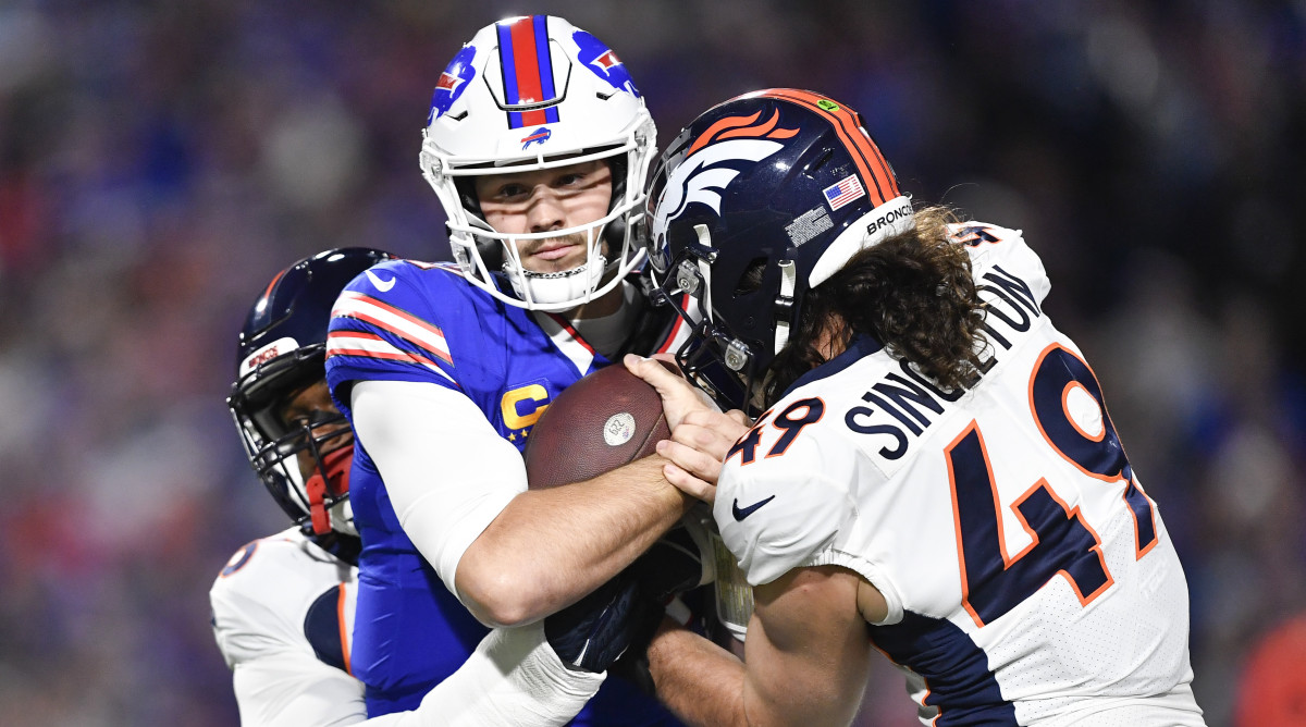 Buffalo Bills quarterback Josh Allen is sacked by Denver Broncos' Baron Browning (left) and Alex Singleton (right).