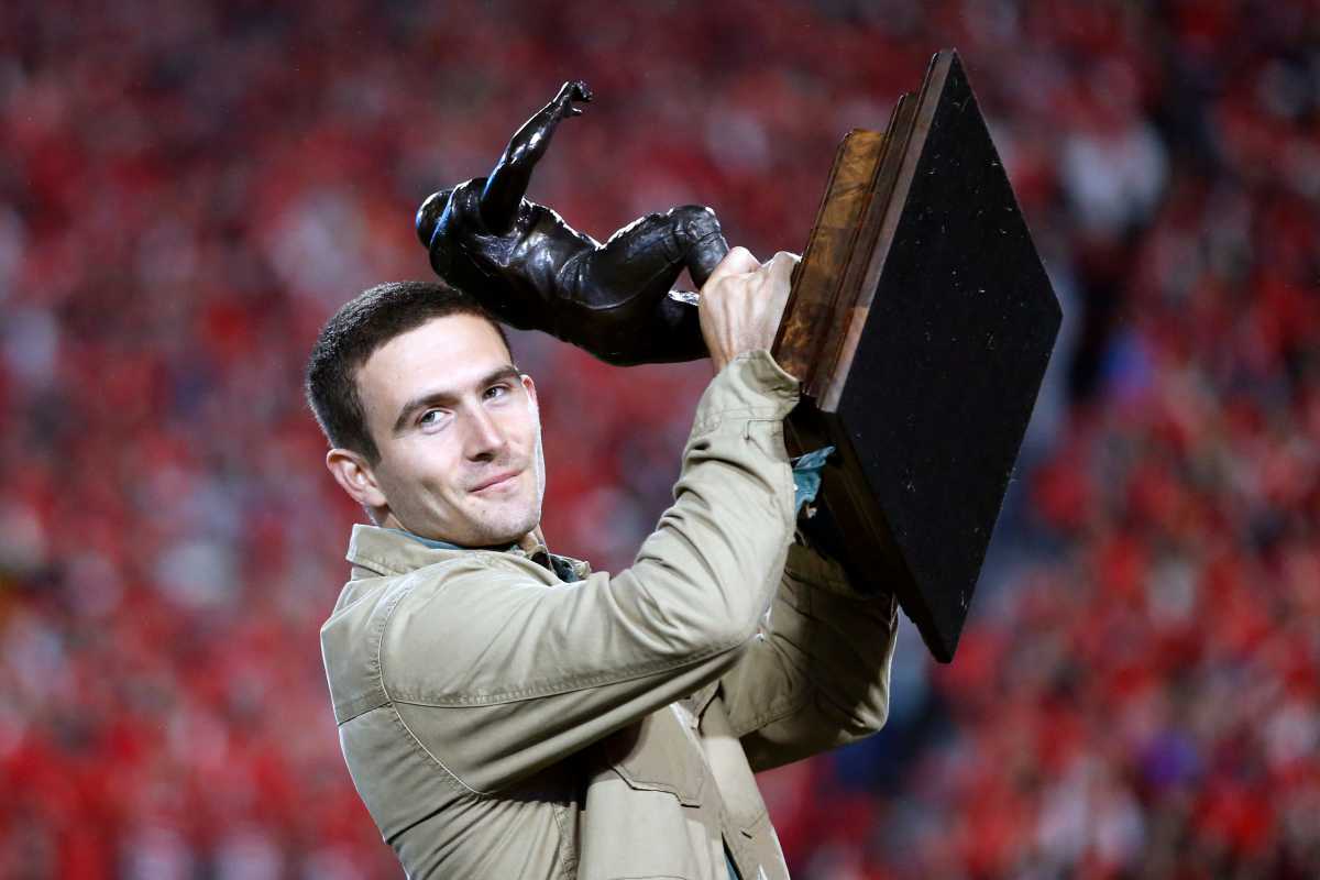 Former Georgia star quarterback Stetson Bennett receives the Burlsworth Trophy during the first half of a NCAA college football game against Ole Miss in Athens, Ga., on Saturday, Nov. 11, 2023.