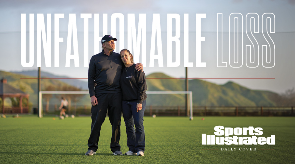 Steve and Gina Meyer stand together on a soccer field.