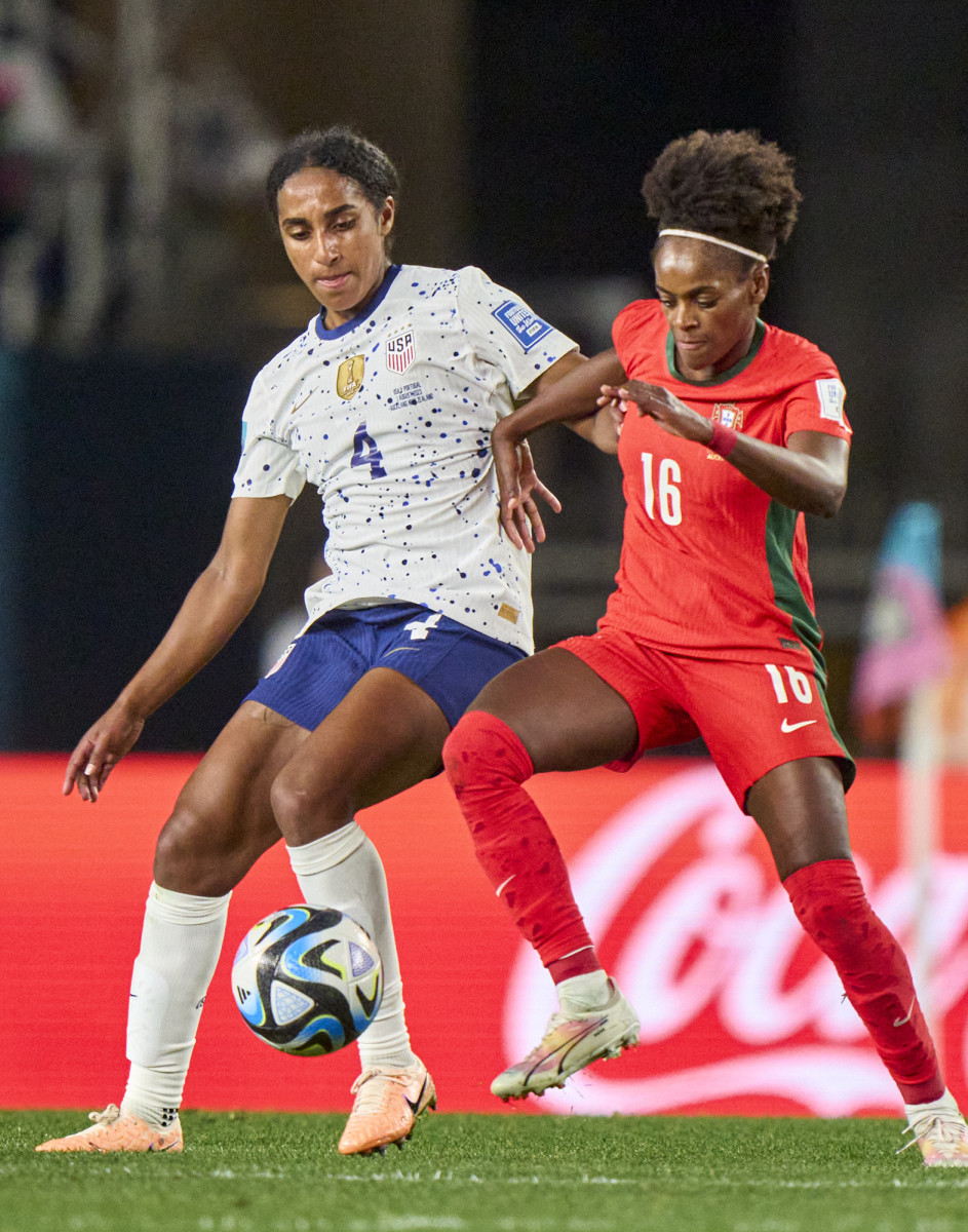 Naomi Girma battles for a ball against a Portugese player during the World Cup.