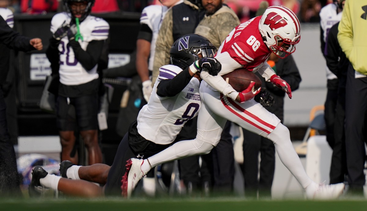 Wisconsin wide receiver Vinny Anthony II (86) is tackled by by Northwestern cornerback Devin Turner (9) after a long reception during the first quarter of their game Saturday, November 11, 2023 at Camp Randall Stadium in Madison, Wisconsin.