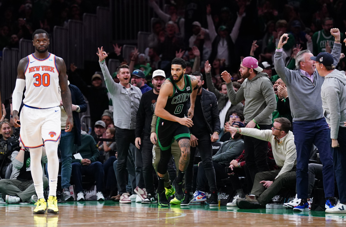 Boston Celtics fans celebrate after forward Jayson Tatum hit a 3-pointer against the New York Knicks in the second half at TD Garden.