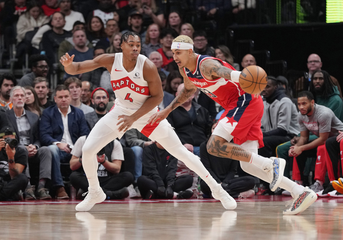 Washington Wizards forward Kyle Kuzma dribbles with the ball as Toronto Raptors forward Scottie Barnes defends during the first quarter at Scotiabank Arena.