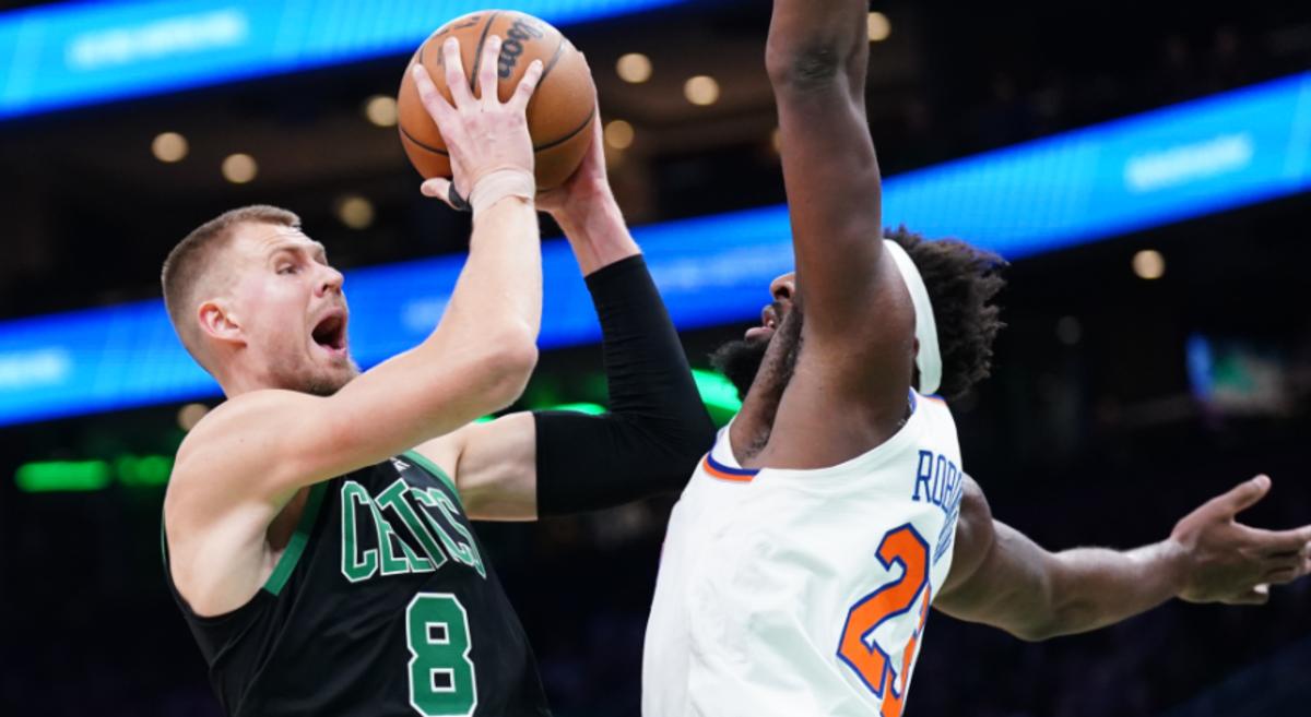 Porzingis (L) drives against Mitchell Robinson in Monday's showdown between the Knicks and Celtics