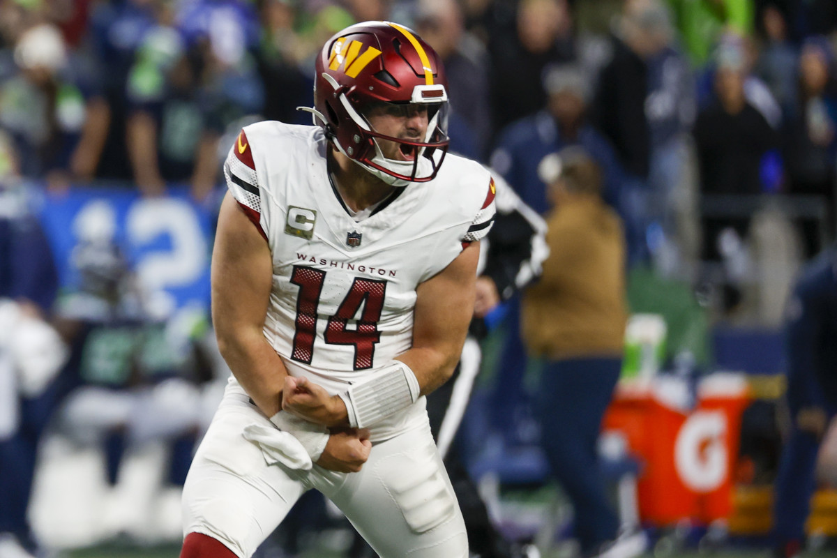 Washington Commanders quarterback Sam Howell (14) celebrates after throwing a touchdown pass against the Seattle Seahawks during the fourth quarter at Lumen Field.