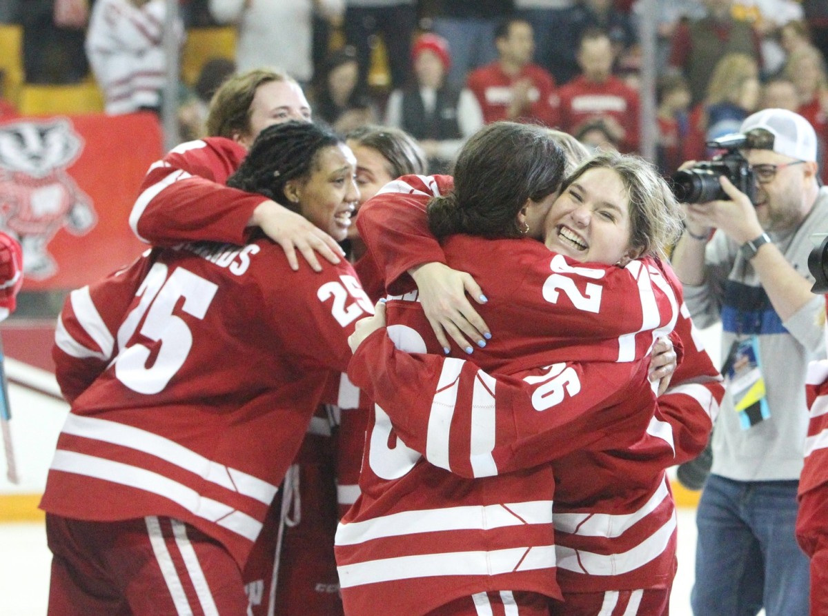 Wisconsin's Casey O'Brien (26) and Maddi Wheeler (28) embrace after the Badgers defeated Ohio State, 1-0, in the NCAA Division I women's hockey national final Sunday March 19, 2023 at AMSOIL Arena in Duluth, Minn. Uwice Ohio State 4 March 19 2023