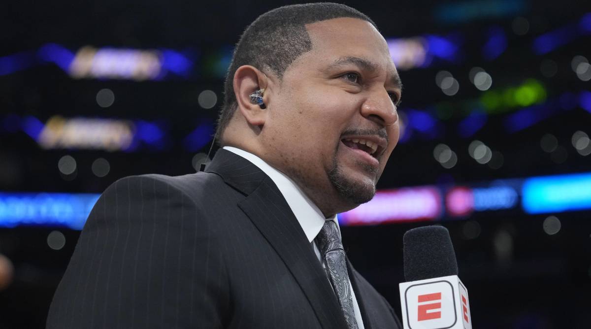 ESPN broadcaster Mark Jackson talks into a microphone during a broadcast.