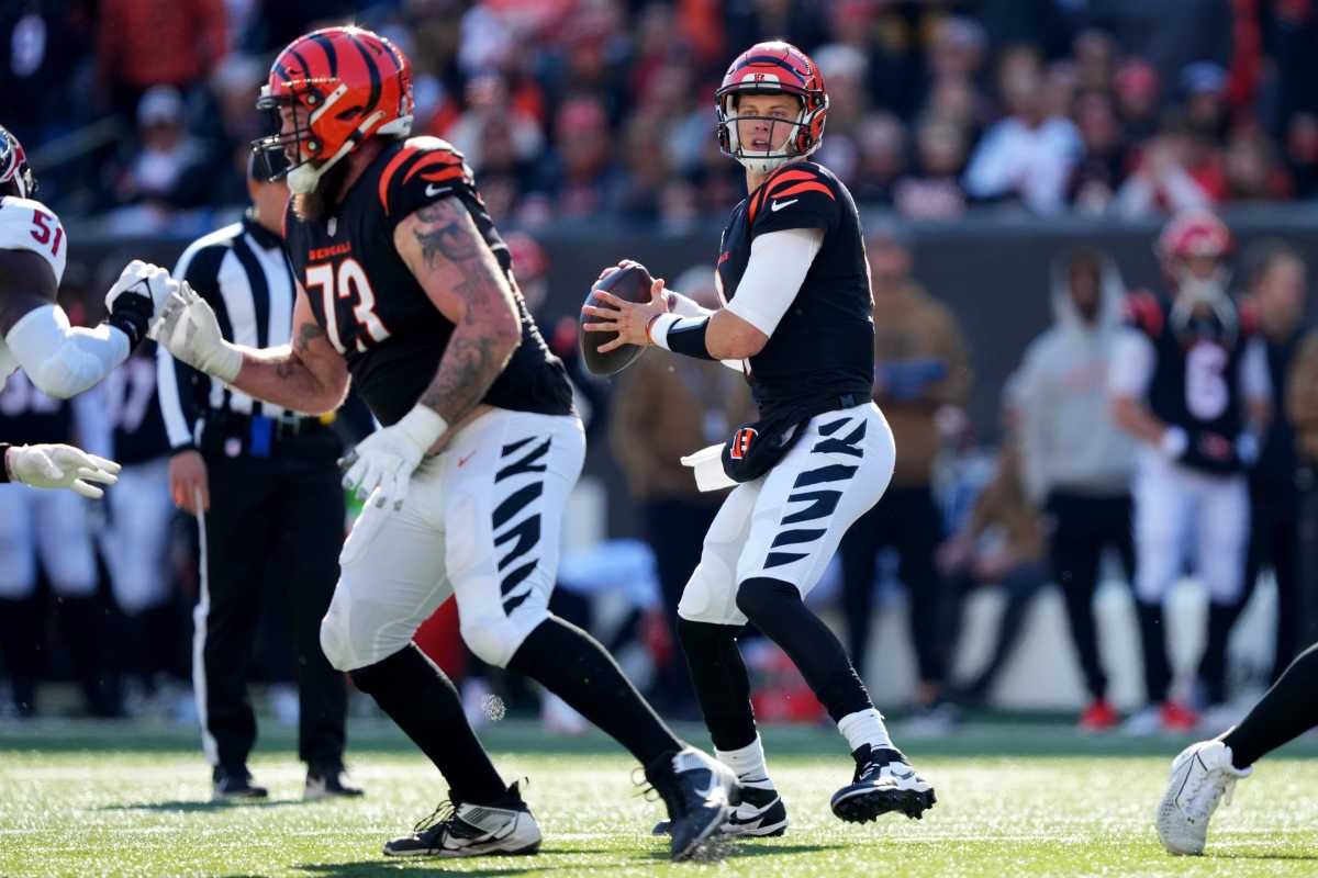Joe Burrow goes to throw the ball as a Bengals O-line man blocks to his side