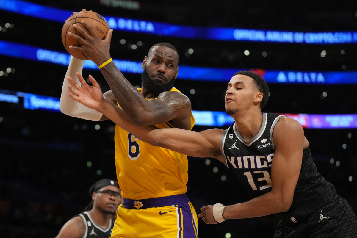 Jan 18, 2023; Los Angeles, California, USA; Los Angeles Lakers forward LeBron James (6) rebounds the ball against Sacramento Kings forward Keegan Murray (13) in the first half at Crypto.com Arena. Mandatory Credit: Kirby Lee-USA TODAY Sports  