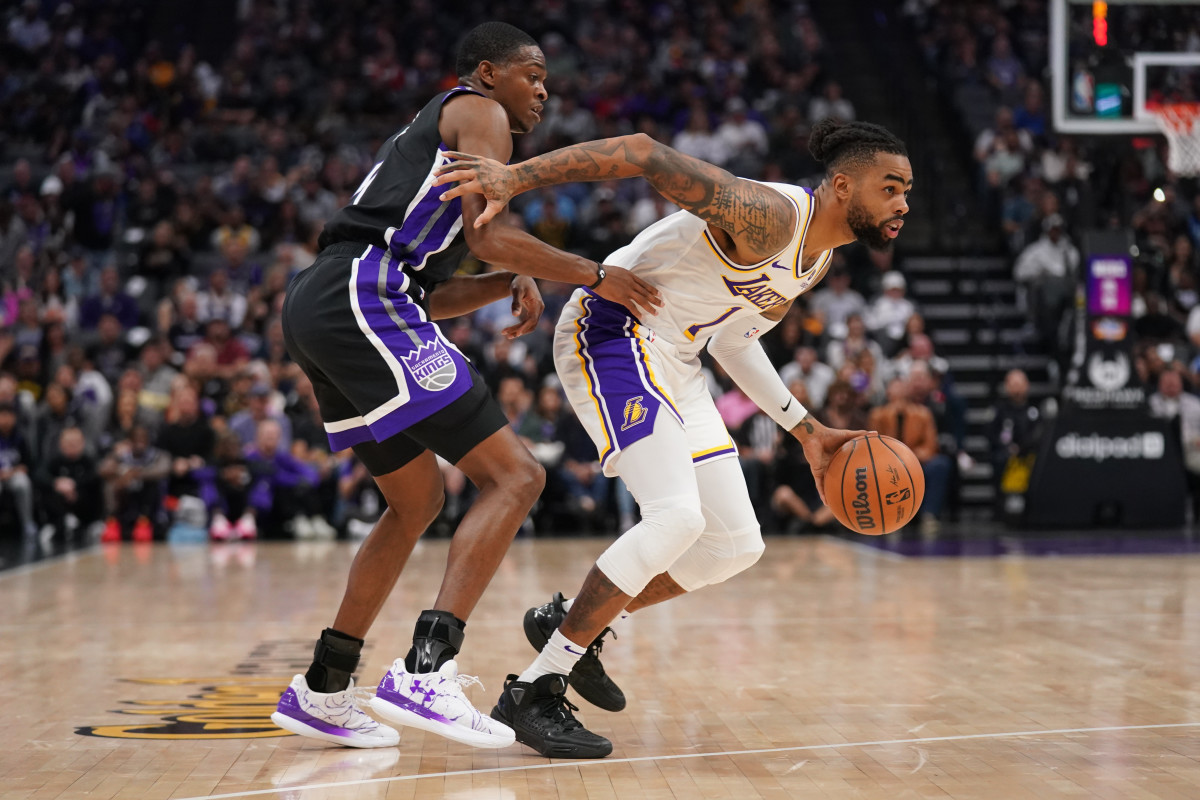 Oct 29, 2023; Sacramento, California, USA; Los Angeles Lakers guard D'Angelo Russell (1) dribbles past Sacramento Kings guard De'Aaron Fox (5) in the second quarter at the Golden 1 Center. Mandatory Credit: Cary Edmondson-USA TODAY Sports  
