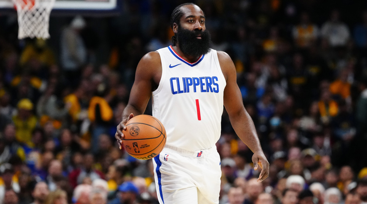 LA Clippers guard James Harden dribbles the ball against the Denver Nuggets at Ball Arena.