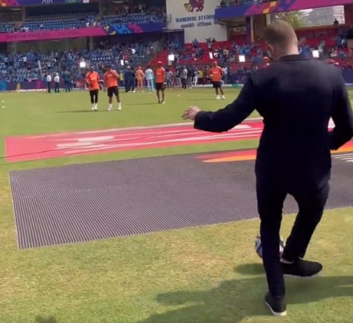 David Beckham pictured passing a soccer ball to cricket star Virat Kohli before India's Cricket World Cup semi-final against New Zealand in November 2023