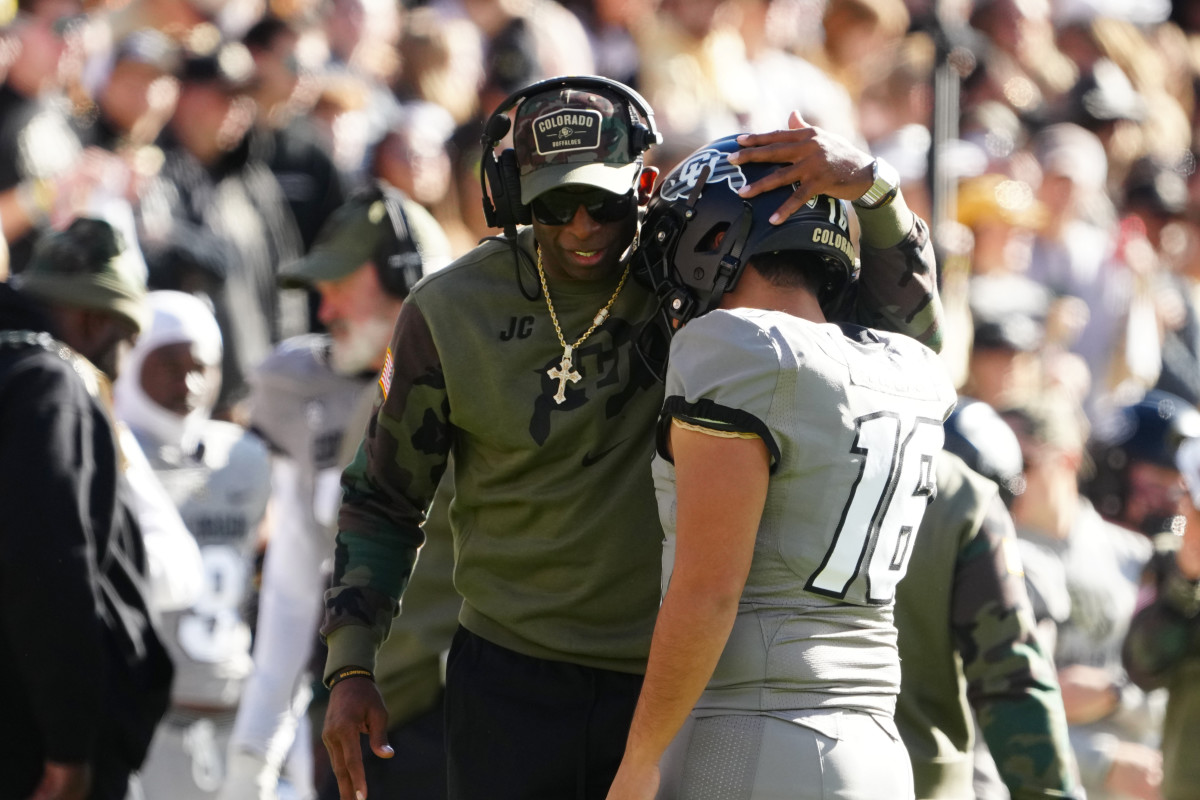 Colorado Buffaloes place kicker Alejandro Mata (16) celebrates with head coach Deion Sanders after kicking a field goal against the Arizona Wildcats in the first half at Folsom Field