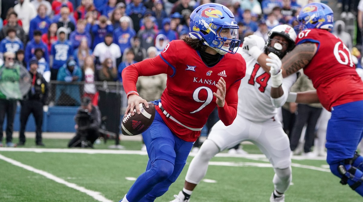 Kansas quarterback Jason Bean (9) scrambles during a game against Texas Tech.