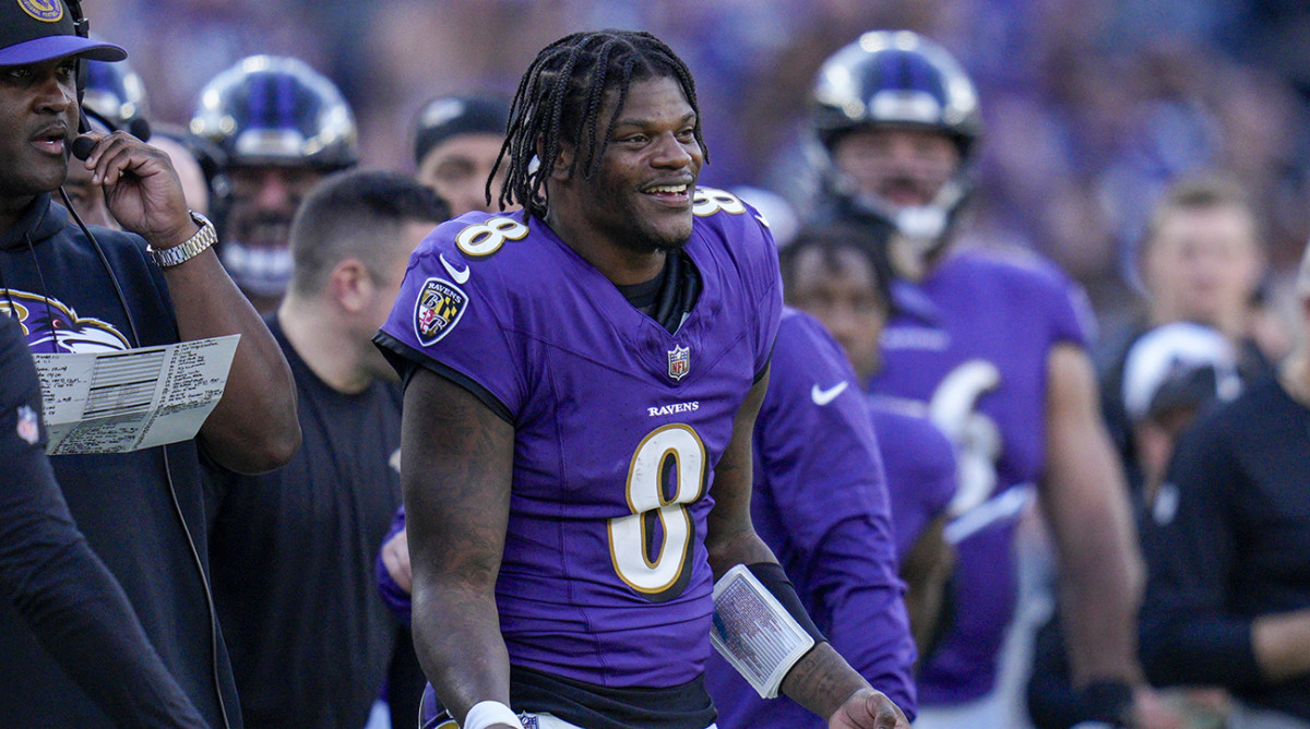 Ravens quarterback Lamar Jackson (8) smiles on the sidelines during the fourth quarter against the Seahawks at M&T Bank Stadium.