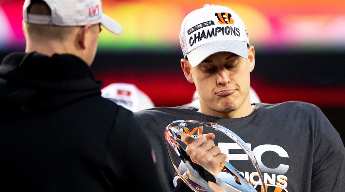 Bengals quarterback Joe Burrow (9) is handed the AFC Championship trophy after the AFC championship  game, Sunday, Jan. 30, 2022.