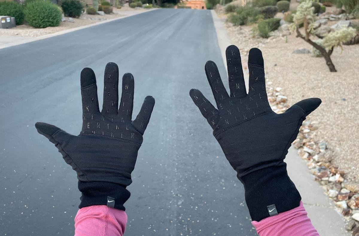 A tester wears Nike gloves in a suburban roadway
