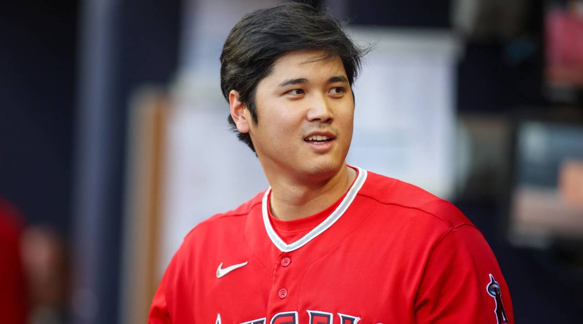 Angels star Shohei Ohtani looks on in the dugout during a game.