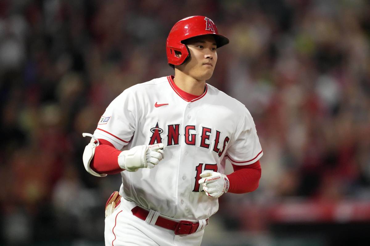 Angels star Shohei Ohtani rounds the bases after hitting a home run in a game.