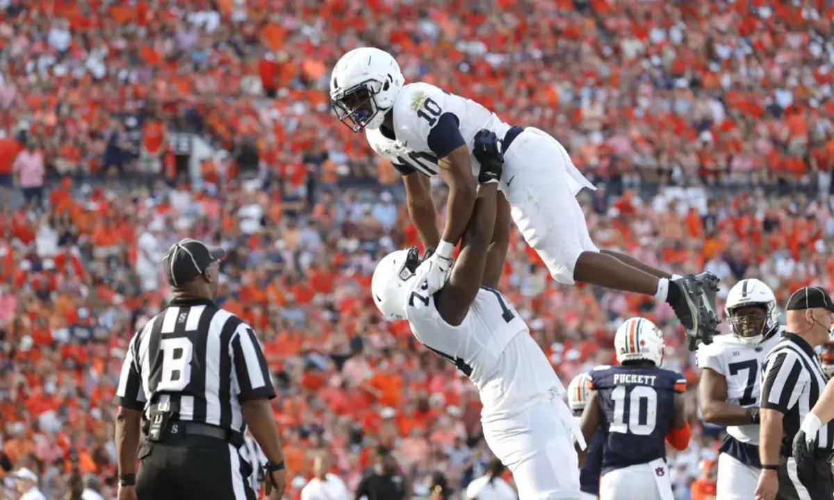 Sep 17, 2022; Auburn, Alabama, USA; Penn State Nittany Lions running back Nicholas Singleton (10) celebrates with offensive lineman Olumuyiwa Fashanu (74) after scoring a touchdown against the Auburn Tigers during the third quarter at Jordan-Hare Stadium.