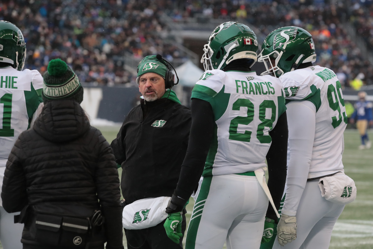 Dec 5, 2021; Winnipeg, Manitoba, CAN; Saskatchewan Roughriders head coach Craig Dickenson (center) talks with players on the sidelines during the game against the Winnipeg Blue Bombers during the Canadian football League Western Conference Final game at IG Field. Mandatory Credit: Bruce Fedyck-USA TODAY Sports