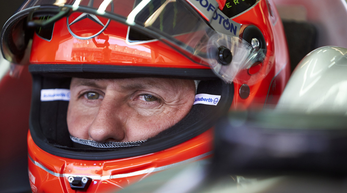 A close-up shot of Mercedes F1 driver Mick Schumacher with his team helmet on.