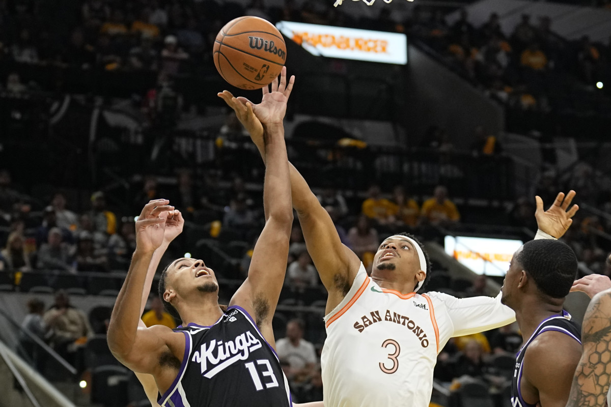 Sacramento Kings forward Keegan Murray (13) and and San Antonio Spurs forward Keldon Johnson (3) battle a rebound during the first half at Frost Bank Center.