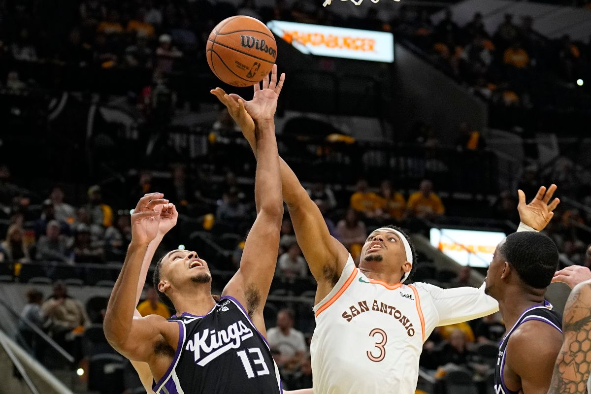 Sacramento Kings forward Keegan Murray (13) and and San Antonio Spurs forward Keldon Johnson (3) battle a rebound during the first half at Frost Bank Center.