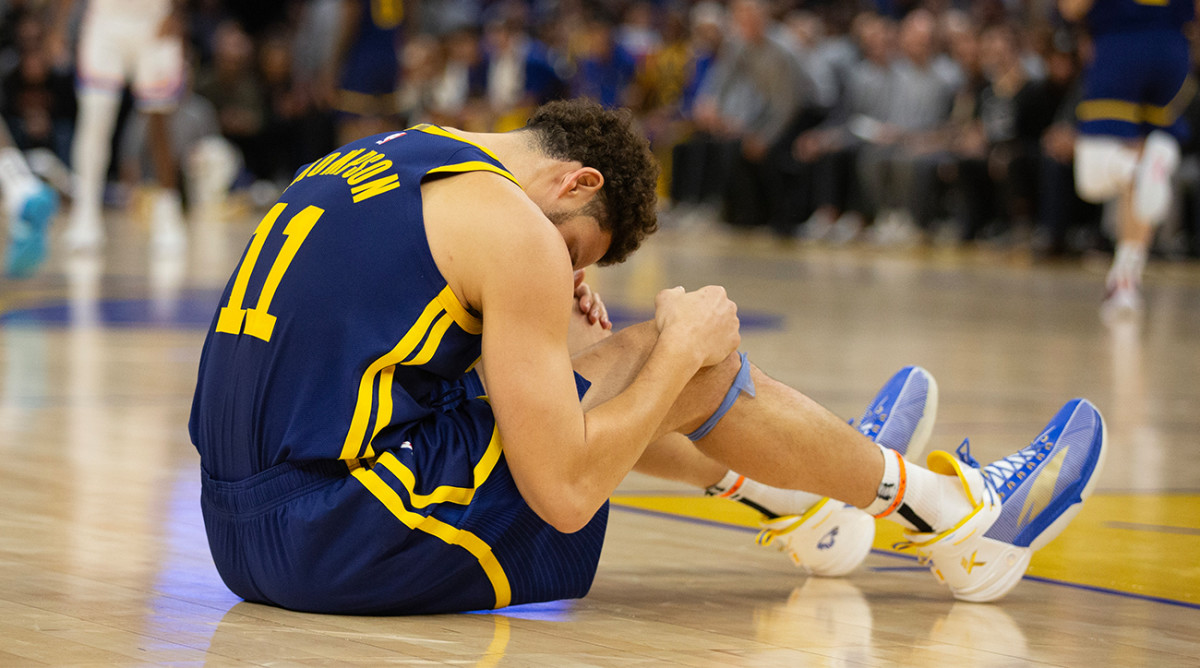 Warriors’ Klay Thompson sits on the floor.