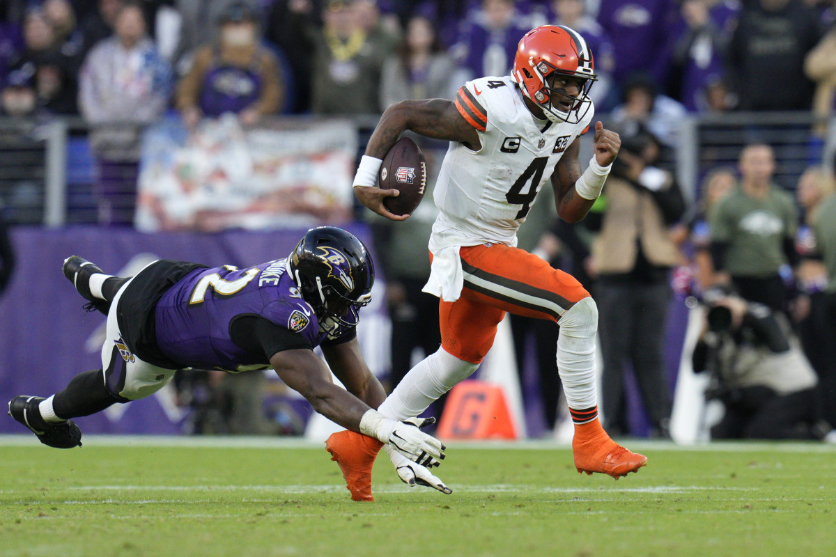 Cleveland Browns quarterback Deshaun Watson (4) runs with the ball as Baltimore Ravens defensive tackle Justin Madubuike (92) defends during the second half at M&T Bank Stadium.