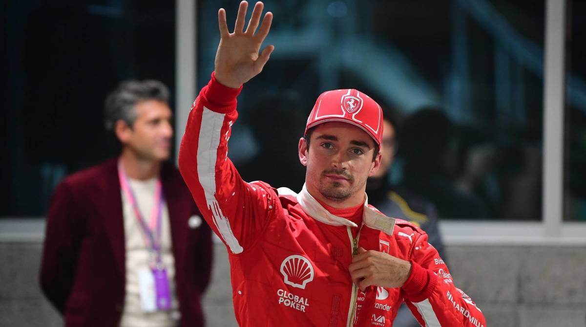 Ferrari driver Charles Leclerc waves at fans after earning the pole position for the Las Vegas Grand Prix.