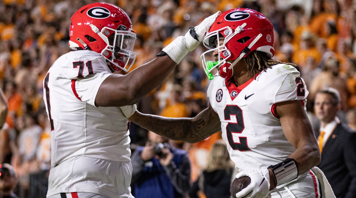 Georgia running back Kendall Milton (2) is congratulated by offensive lineman Earnest Greene III (71) after scoring a touchdown during a game against Tennessee.