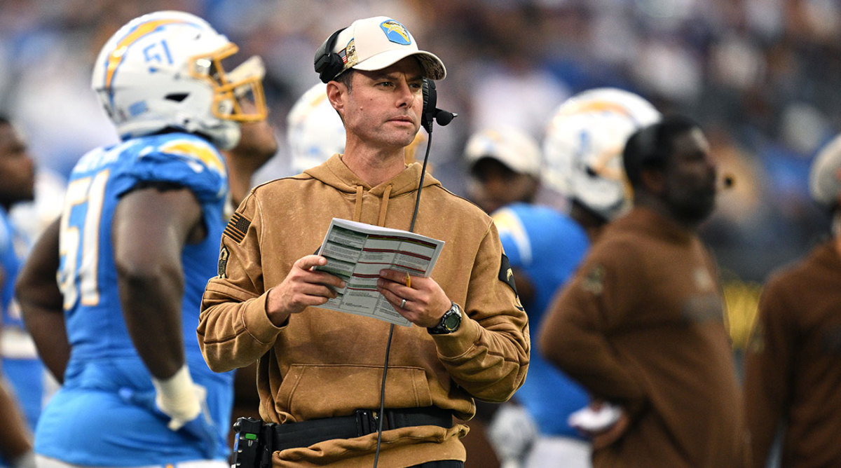 Brandon Staley looks out at the field from the sideline during a game.