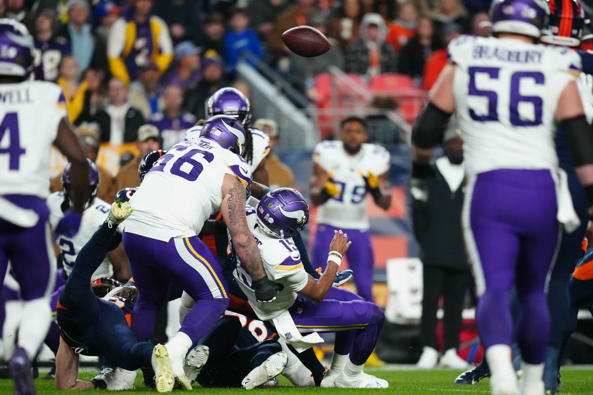 Minnesota Vikings quarterback Joshua Dobb fumbles against the Denver Broncos in the first quarter at Empower Field at Mile High.