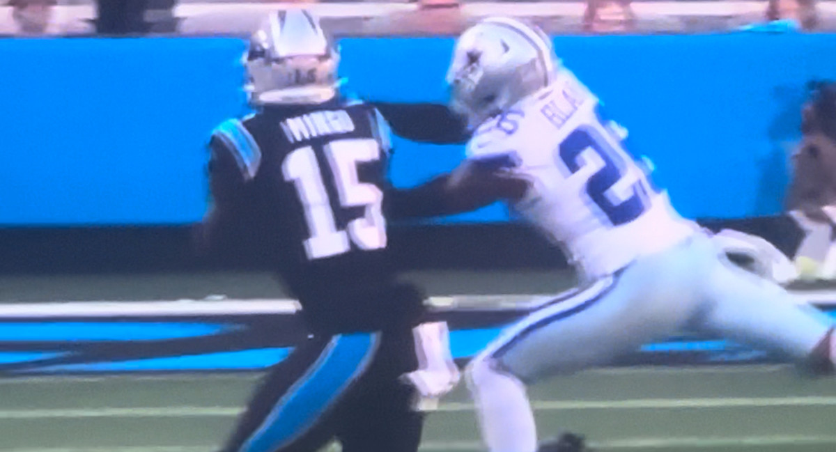 Dallas Cowboys cornerback Daron Bland (right) intercepts Carolina Panthers quarterback Bryce Young's pass. 