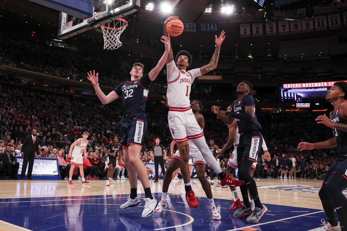 Indiana Hoosiers center Kel'el Ware (1) rebounds against Connecticut Huskies center Donovan Clingan (32) and forward Samson Johnson (35) during the first half at Madison Square Garden. 