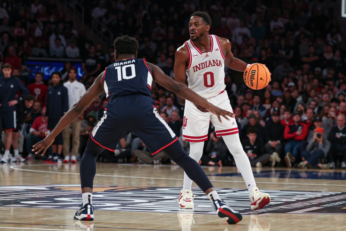  Indiana Hoosiers guard Xavier Johnson (0) dribbles against Connecticut Huskies guard Hassan Diarra (10) during the second half at Madison Square Garden. 